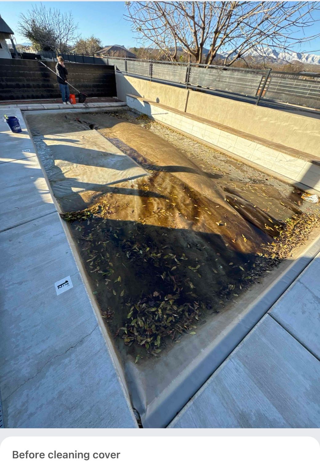 Pool cover covered in leaves and debris before cleaning